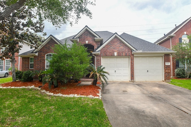view of front of house with brick siding, driveway, a front lawn, and a garage