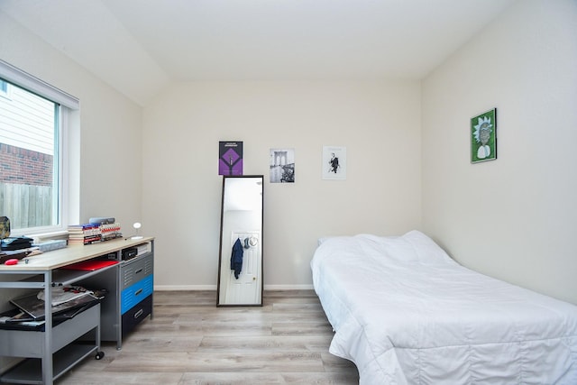 bedroom featuring baseboards and light wood-style flooring
