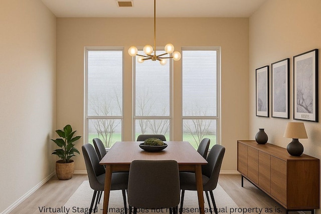 1026 Jasons Bend Dr, Sugar Land, TX 77479 - dining room featuring a chandelier, light wood-style flooring, and baseboards