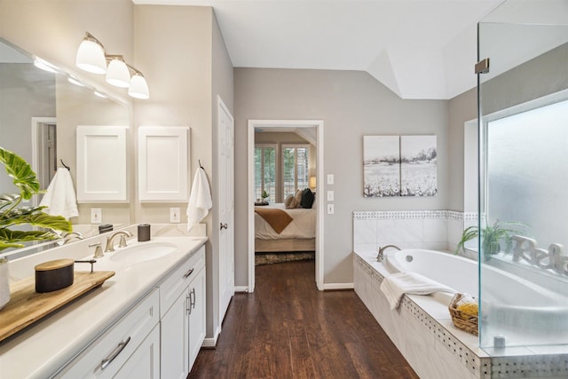 14718 Kings Head Dr, Houston, TX 77044 - ensuite bathroom featuring vanity, wood finished floors, baseboards, ensuite bathroom, and a bath