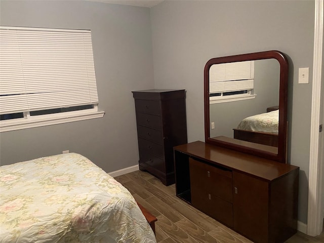bedroom with wood tiled floor and baseboards
