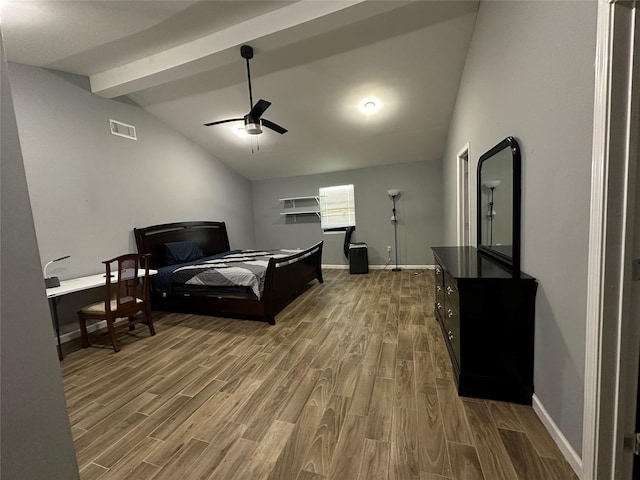 bedroom featuring ceiling fan, visible vents, wood finished floors, baseboards, and vaulted ceiling with beams