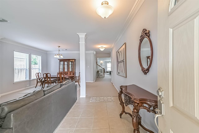 interior space with crown molding, baseboards, light tile patterned flooring, and visible vents