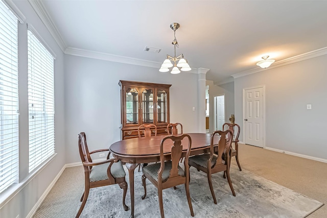 dining area with visible vents, ornamental molding, a healthy amount of sunlight, and light colored carpet