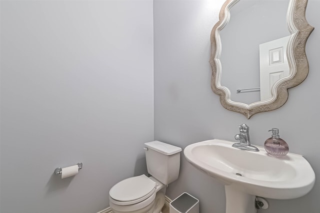 half bath with a sink and toilet