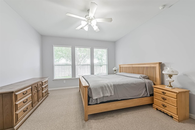 bedroom featuring baseboards, a ceiling fan, and light carpet