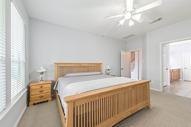 bedroom featuring baseboards, multiple windows, light carpet, and visible vents