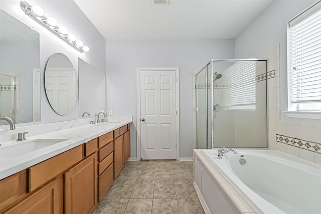 full bath featuring a sink, a stall shower, and a bath