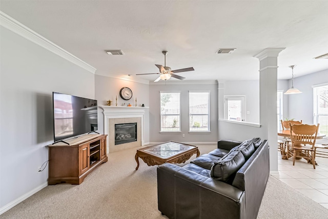 living room with a wealth of natural light, ceiling fan, and visible vents