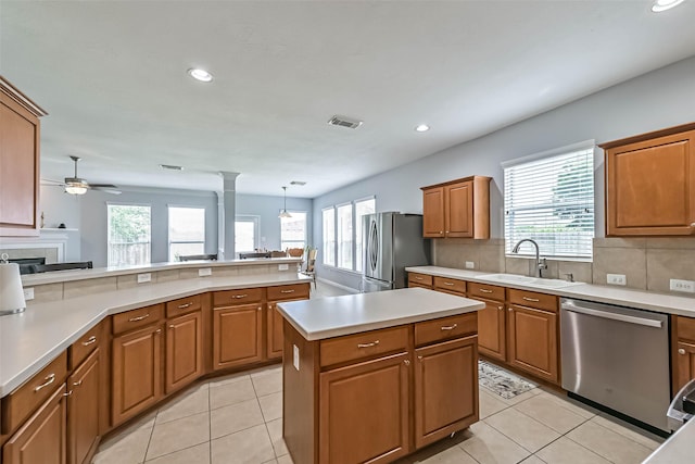 kitchen featuring light countertops, a sink, a wealth of natural light, and stainless steel appliances