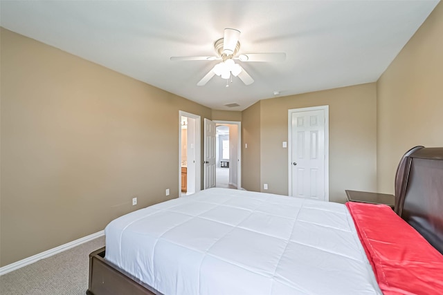 bedroom with carpet floors, baseboards, ensuite bathroom, and a ceiling fan
