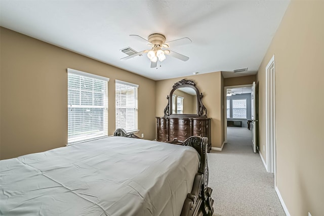 bedroom featuring visible vents, a ceiling fan, baseboards, and light carpet