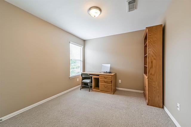 carpeted office with visible vents and baseboards