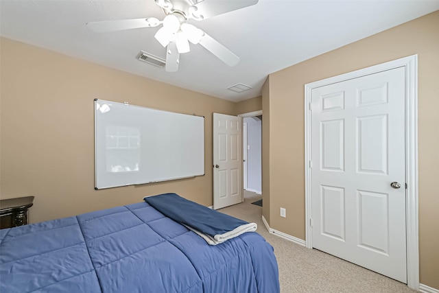 bedroom featuring visible vents, baseboards, ceiling fan, and light carpet
