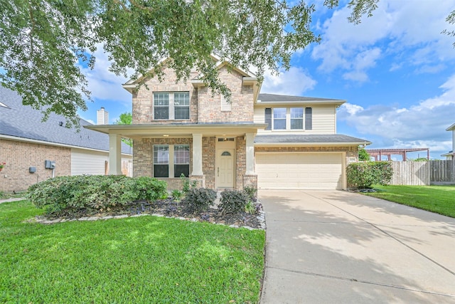 traditional-style home featuring fence, brick siding, a garage, a front yard, and concrete driveway
