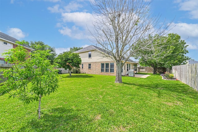 view of yard with a fenced backyard and a patio area