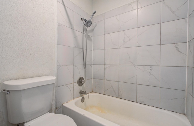 bathroom with toilet and bathtub / shower combination