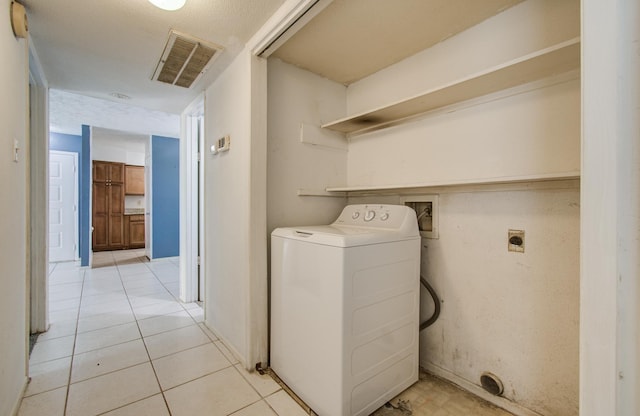 washroom featuring visible vents, washer / dryer, and light tile patterned floors