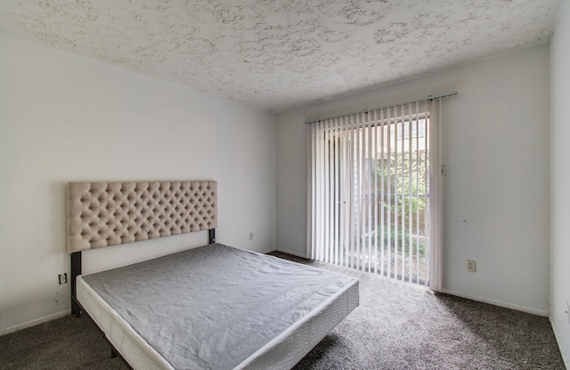carpeted bedroom with baseboards, a textured ceiling, and access to exterior