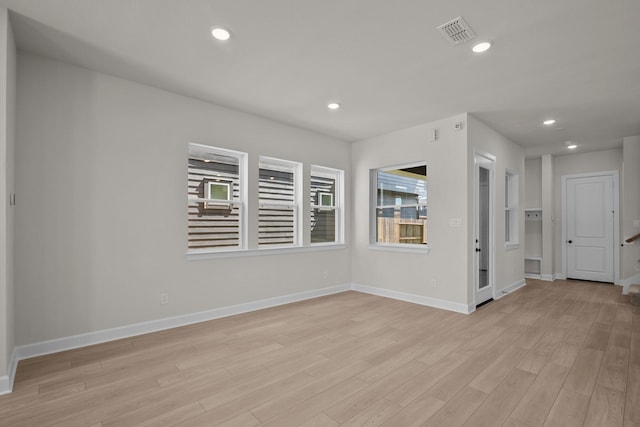 empty room with recessed lighting, baseboards, visible vents, and light wood-type flooring