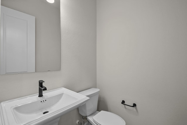bathroom with toilet and a sink
