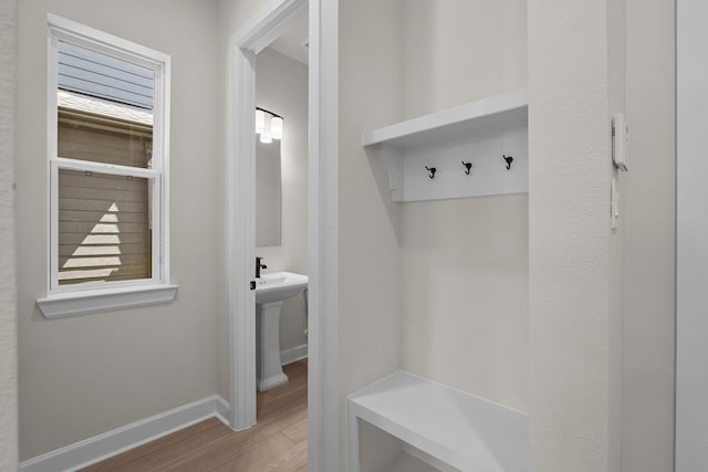 mudroom featuring baseboards and wood finished floors
