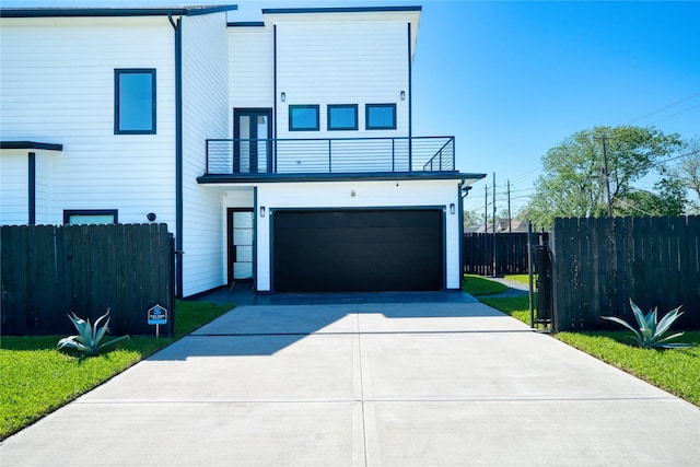 2420 Sumpter St, Houston, TX 77026 - view of front of home featuring a garage, fence, a balcony, and driveway