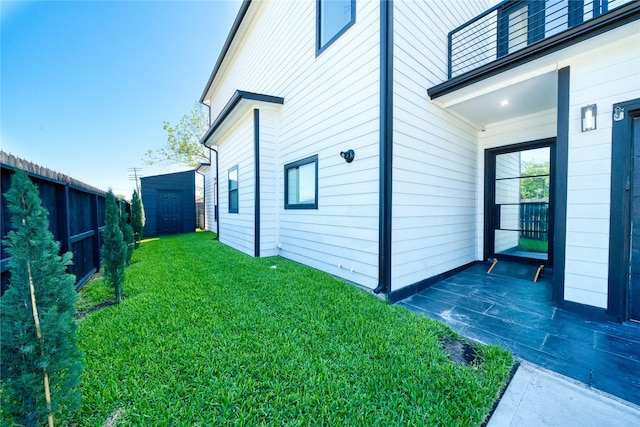 2420 Sumpter St, Houston, TX 77026 - view of side of home with a yard, an outdoor structure, and a shed