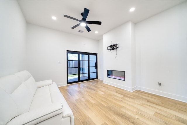 2420 Sumpter St, Houston, TX 77026 - living room with visible vents, a glass covered fireplace, baseboards, recessed lighting, and light wood finished floors