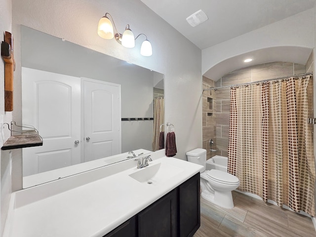bathroom featuring vanity, shower / bath combo, toilet, and visible vents
