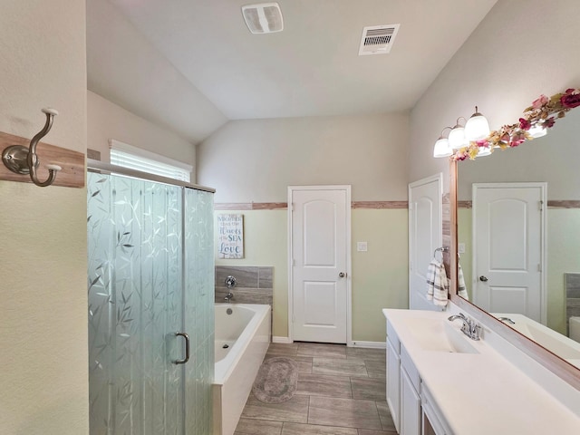 bathroom with vanity, a shower stall, a bath, and visible vents