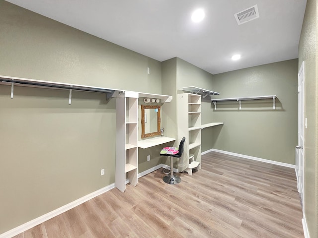 walk in closet featuring light wood finished floors and visible vents