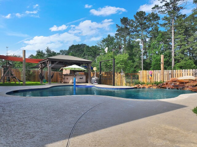 view of swimming pool featuring a gazebo, a fenced backyard, a playground, and a fenced in pool