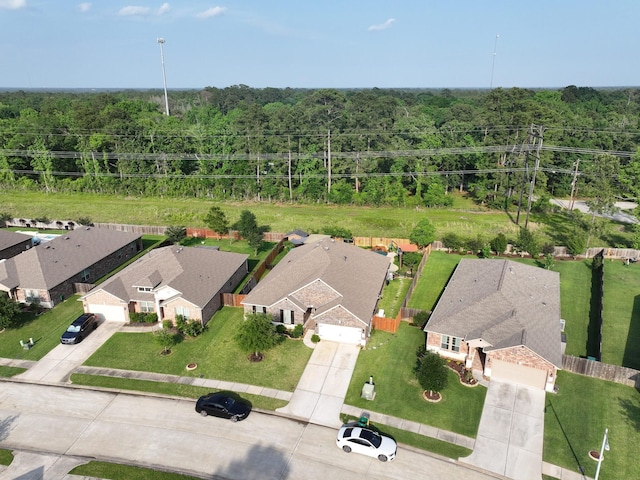 aerial view featuring a residential view and a wooded view