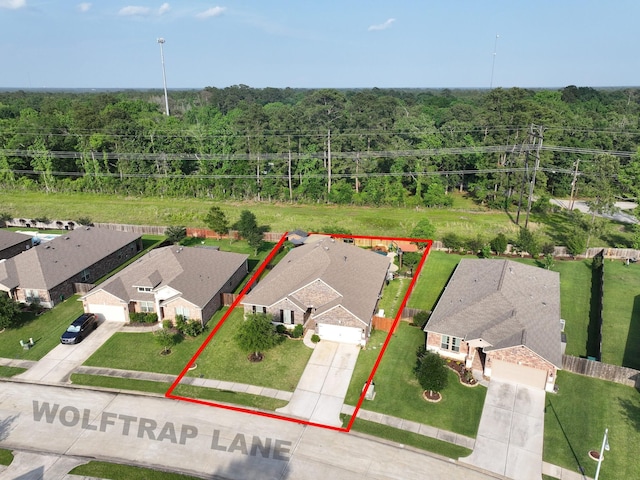 drone / aerial view featuring a view of trees and a residential view