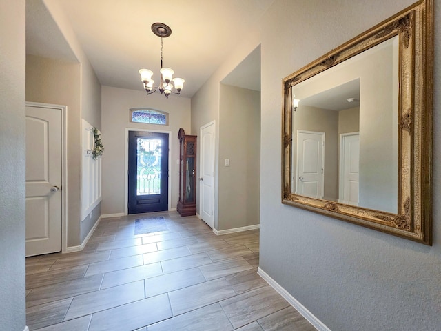 entrance foyer featuring baseboards and a notable chandelier