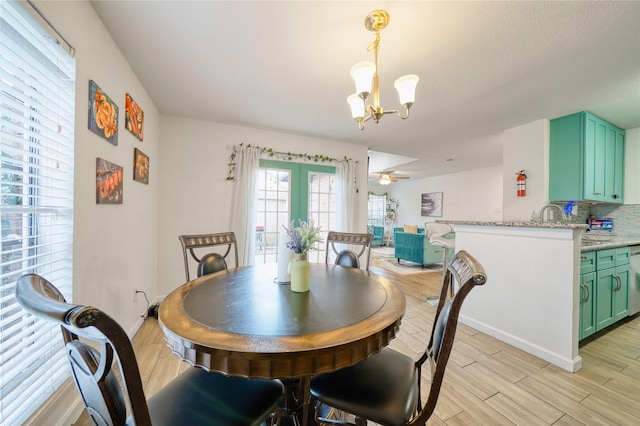10912 Gulf Fwy Unit 28, Houston, TX 77034 - dining area featuring a chandelier, light wood-style floors, baseboards, and ceiling fan