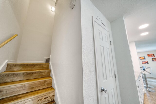 10912 Gulf Fwy Unit 28, Houston, TX 77034 - stairs featuring wood finished floors and recessed lighting