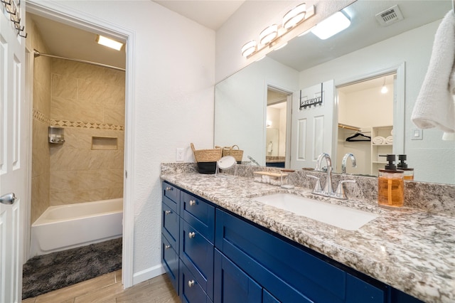 10912 Gulf Fwy Unit 28, Houston, TX 77034 - bathroom with wood finished floors, vanity, and tub / shower combination