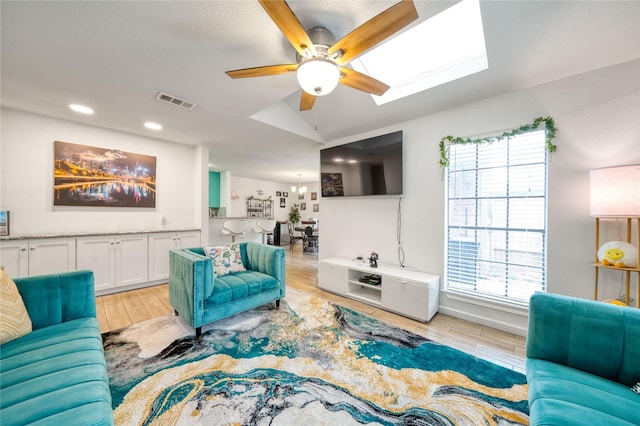 10912 Gulf Fwy Unit 28, Houston, TX 77034 - living room featuring ceiling fan, light wood-type flooring, recessed lighting, and a skylight