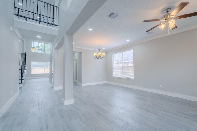 interior space with visible vents, ornamental molding, stairs, wood finished floors, and baseboards