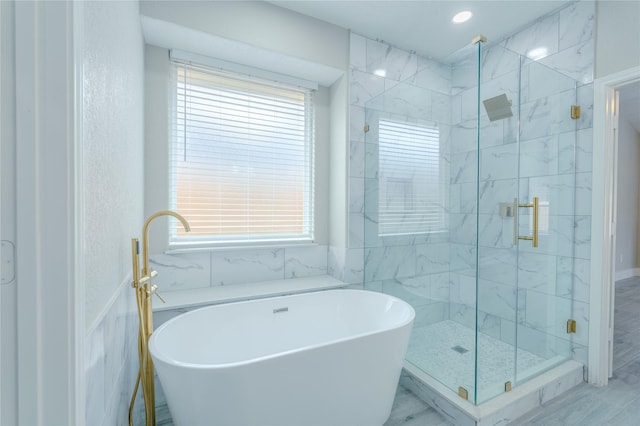 full bathroom with a freestanding tub and a stall shower