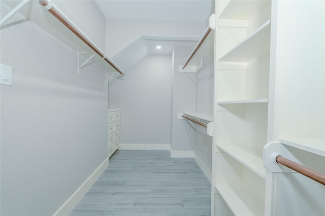 spacious closet featuring light wood-style flooring