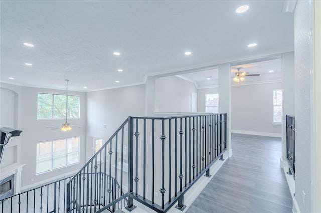 hallway with recessed lighting, an upstairs landing, ornamental molding, and wood finished floors