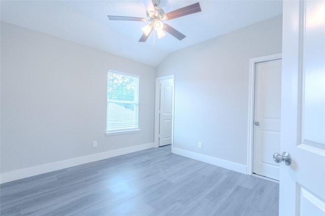 unfurnished bedroom with baseboards, ceiling fan, light wood-style flooring, and lofted ceiling