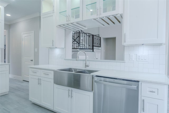 kitchen with a sink, white cabinetry, dishwasher, and glass insert cabinets
