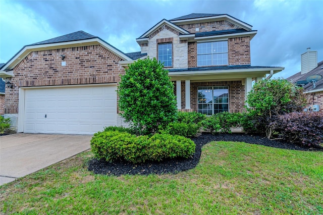 view of front of property with an attached garage, concrete driveway, a front yard, and brick siding