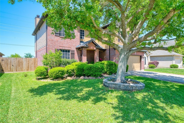 traditional-style house with fence, a front yard, a chimney, brick siding, and concrete driveway