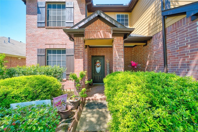 property entrance with brick siding