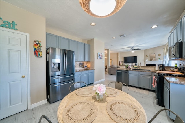 kitchen with recessed lighting, baseboards, appliances with stainless steel finishes, and open floor plan